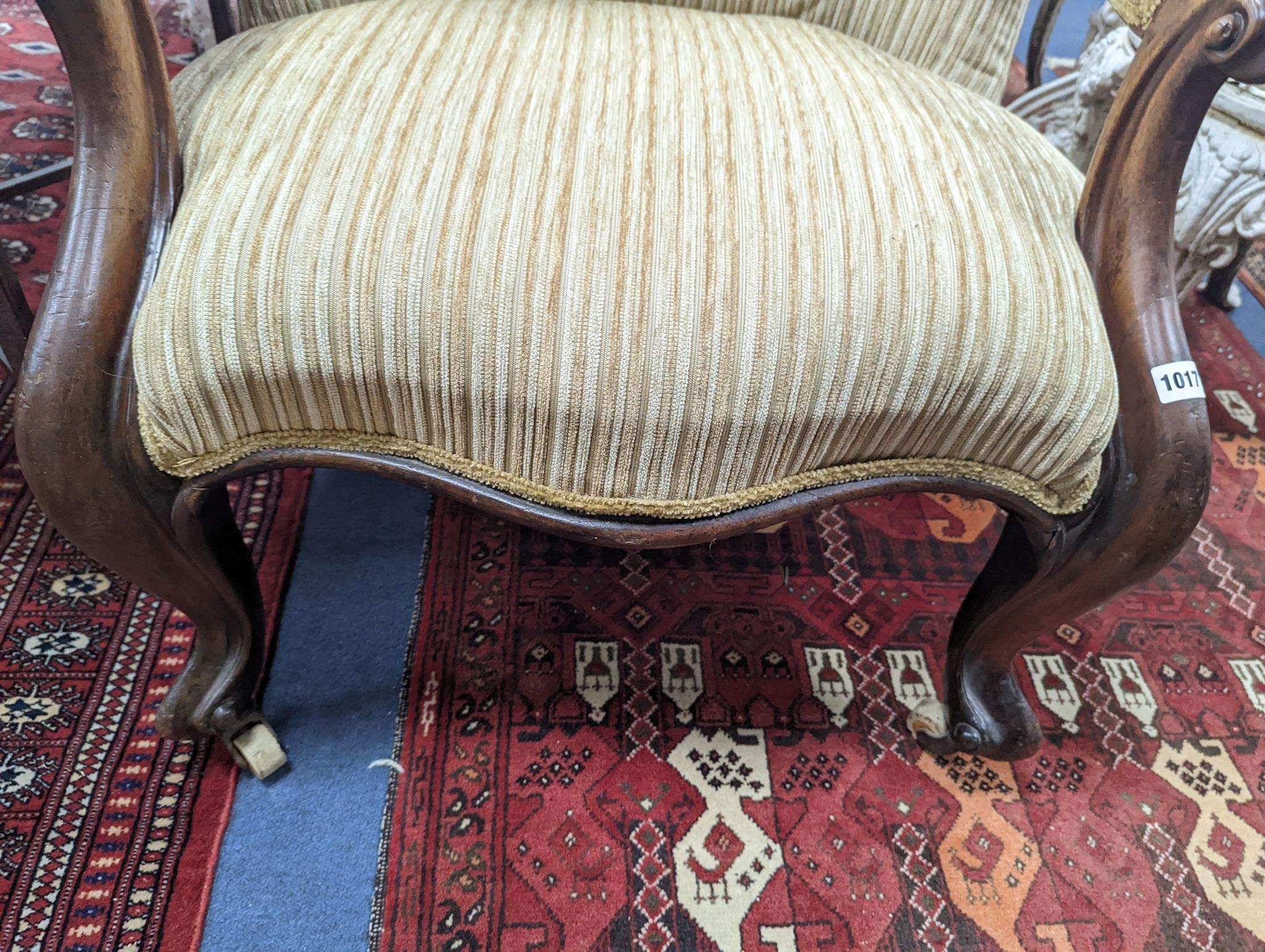 A Victorian upholstered spoon back armchair, width 71cm, depth 74cm, height 102cm